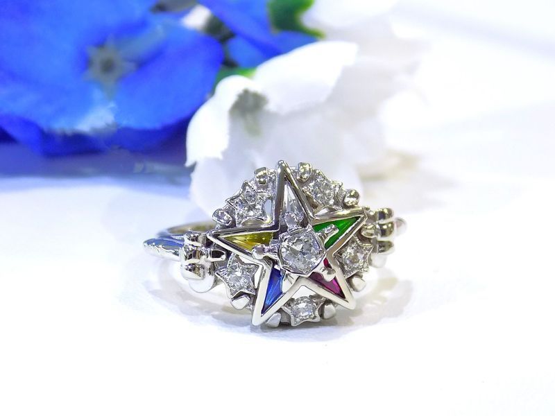 Silver Eastern Star ring with a central diamond and colored star points, surrounded by small diamonds