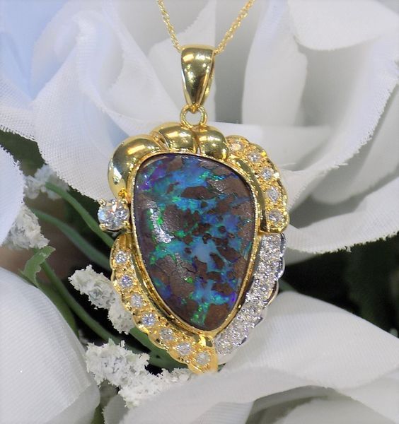 Gold pendant with a dark, colorful opal gemstone and small diamonds