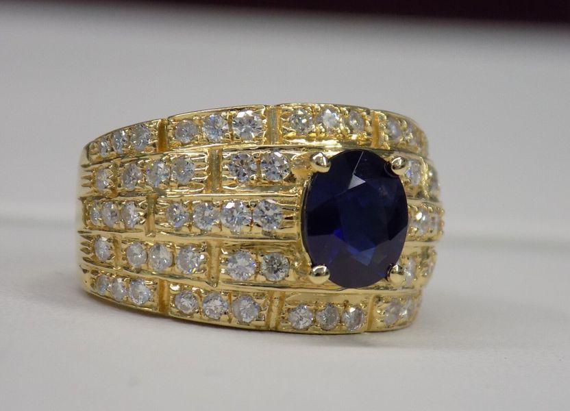 Gold ring with a large oval blue sapphire and small diamonds