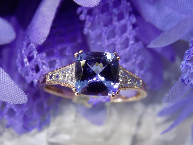 Tanzanite ring with diamond accents set on a gold band