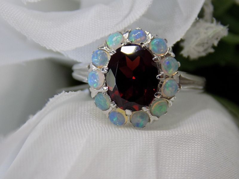 Oval garnet ring with halo of opals