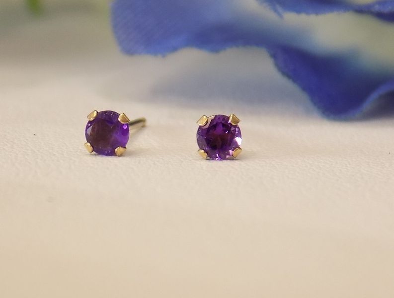 Amethyst stud earrings on white surface