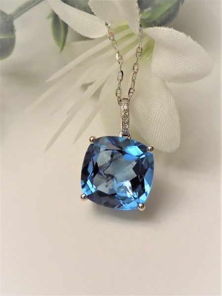 Blue gemstone pendant necklace on white background