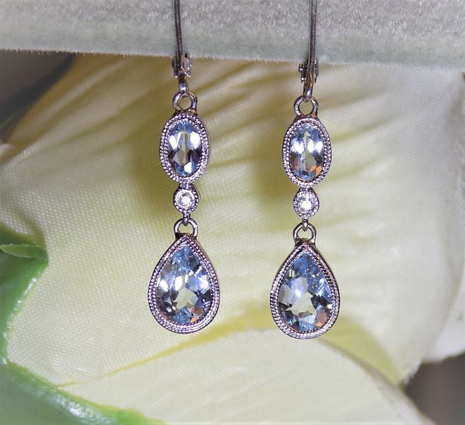 Silver earrings with blue teardrop and oval gemstones
