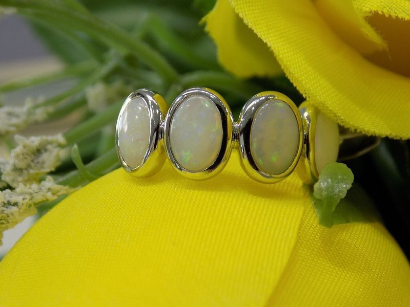 Silver ring with four oval opals