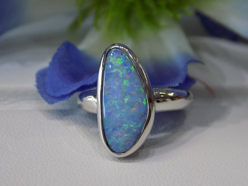 Silver ring with large, light blue opal gemstone,