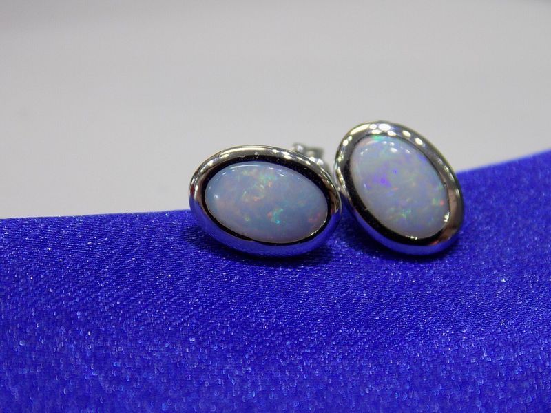 Oval opal stud earrings with silver settings