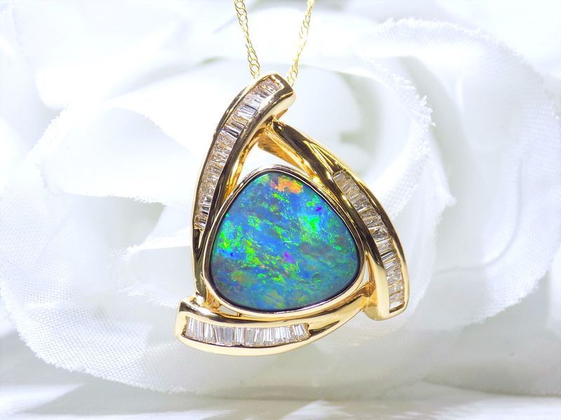 Gold pendant with a triangular opal gemstone
