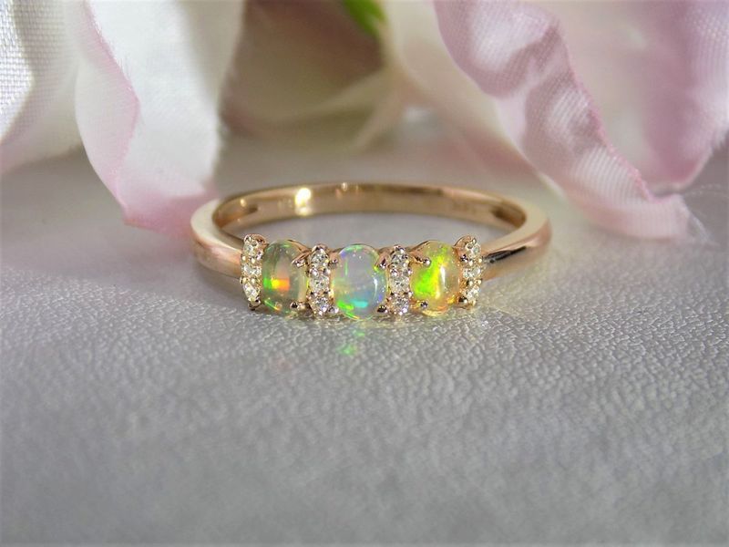 Gold ring with three opals and small diamonds
