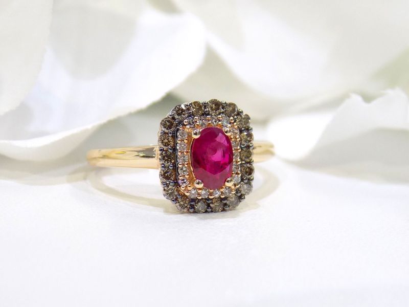 Gold ring with oval ruby center