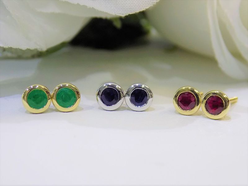 Three pairs of jewel-toned stud earrings