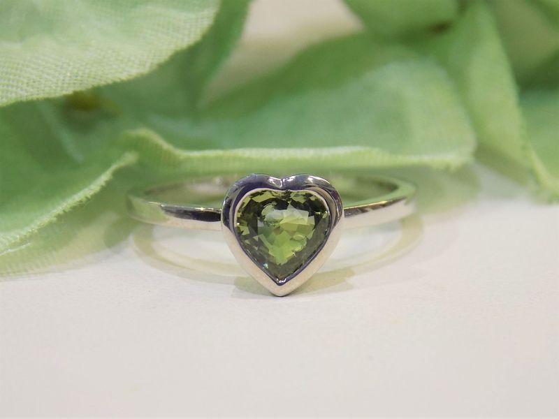 Heart-shaped peridot gemstone ring in silver setting