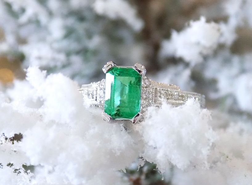 Emerald ring on snowy branch