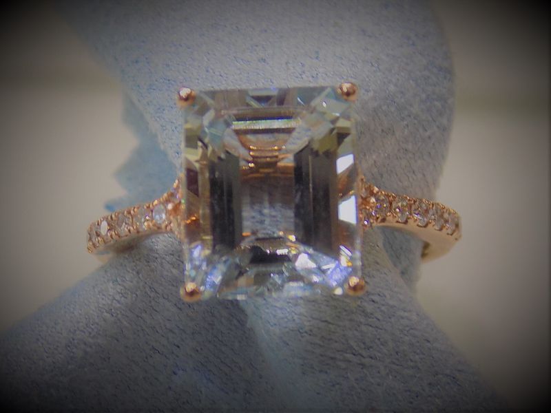 Rose gold ring with rectangular pale blue gemstone