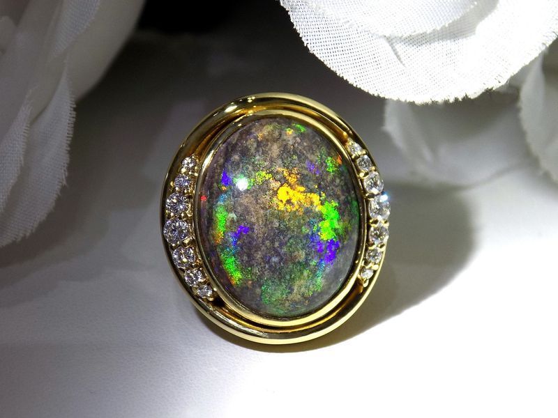 Gold ring with an oval black opal