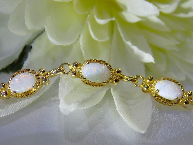 Gold bracelet with oval opal stones