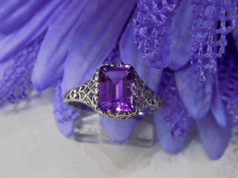 Silver ring with a large rectangular purple gemstone set 