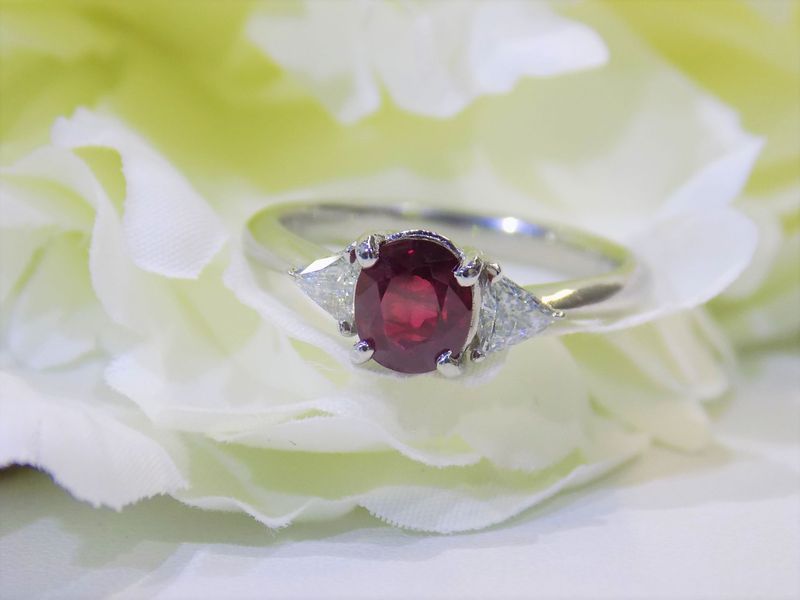 Ruby ring with two triangular diamonds