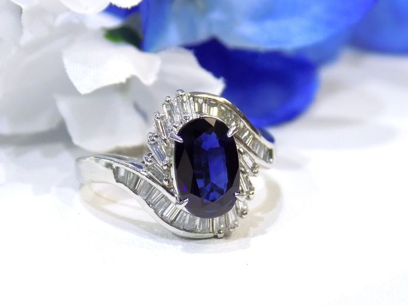Sapphire and diamond ring with an oval blue gem