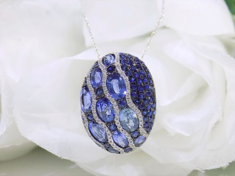 Oval pendant necklace with blue sapphires and diamonds