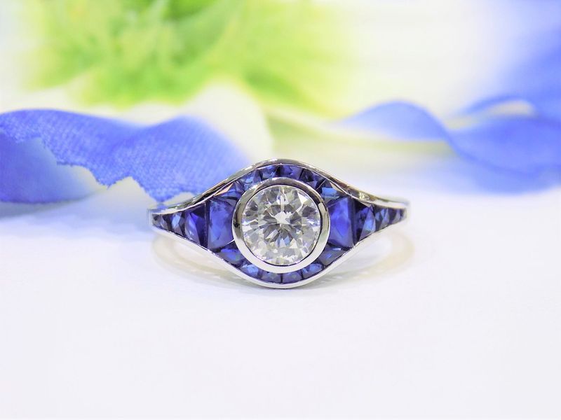 Diamond engagement ring with blue sapphire accents