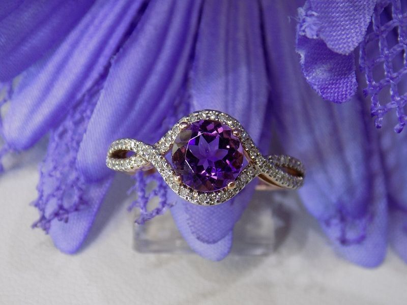 Rose gold ring with a large purple gemstone