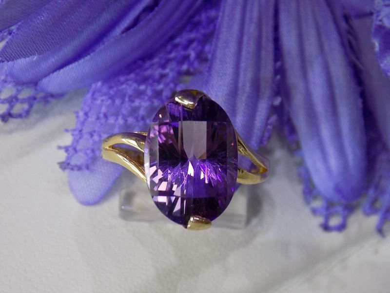 Gold ring with large, oval-cut purple amethyst
