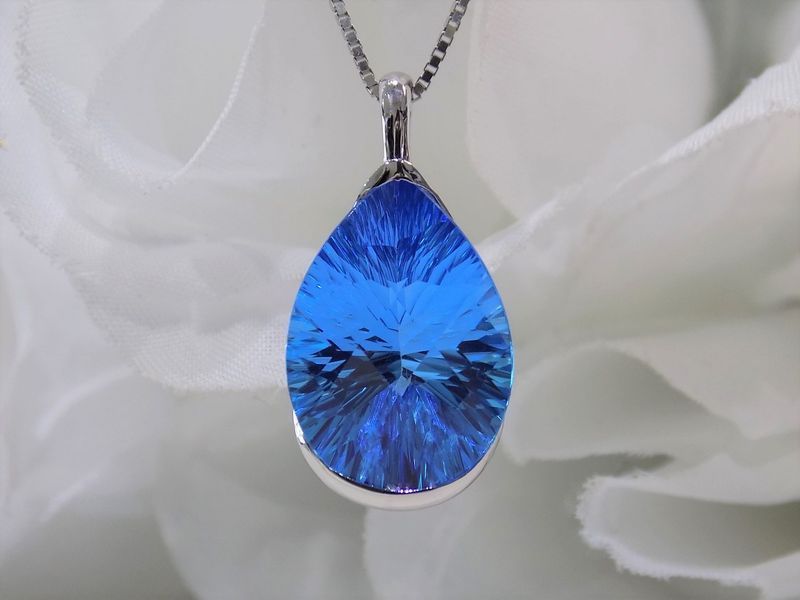 Blue teardrop-shaped gemstone pendant on a silver chain