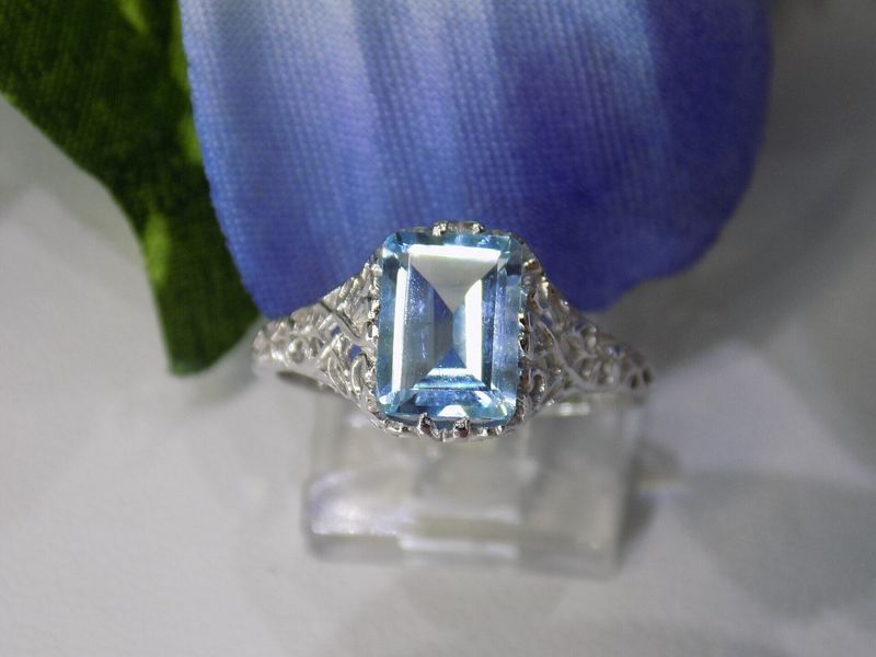 Silver ring with an emerald-cut, light blue gemstone