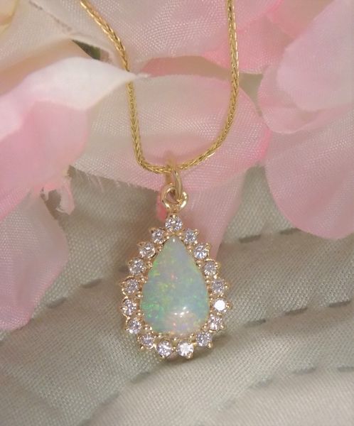 Gold necklace with a pear-shaped opal pendant