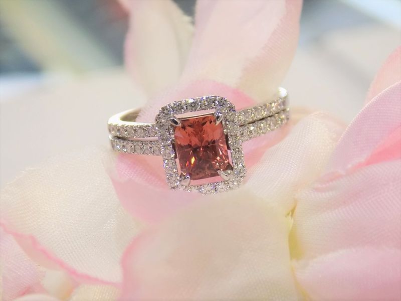 Diamond engagement ring with a peach-colored center stone
