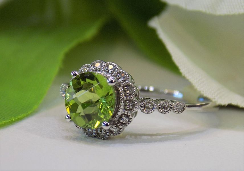 Oval peridot gemstone ring in an intricate setting