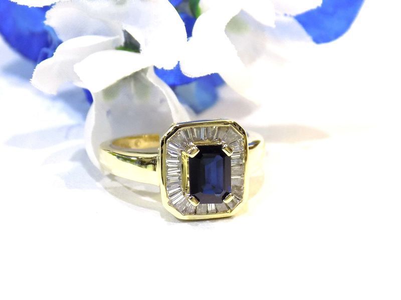 Gold ring with a rectangular blue sapphire center stone 