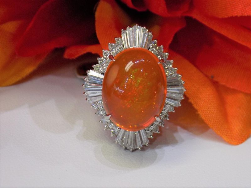 Orange gemstone ring with white baguette-cut diamonds