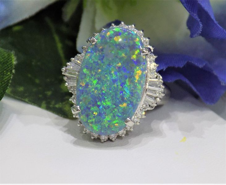 Oval opal ring with a halo of white stones