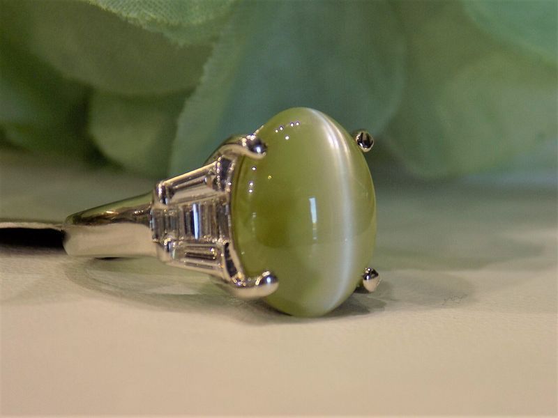 Green cat's eye gemstone ring with a silver band