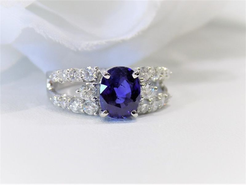 Oval sapphire ring with diamond halo and split band