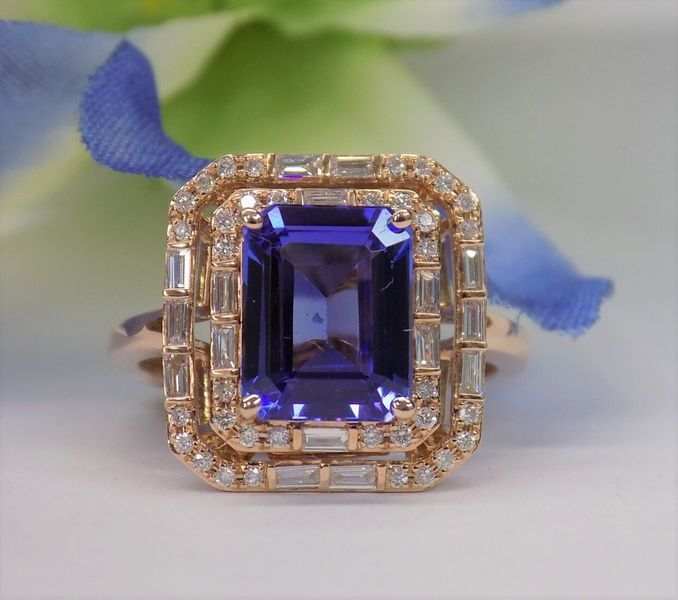 Rose gold ring with a square purple gemstone and diamond halo