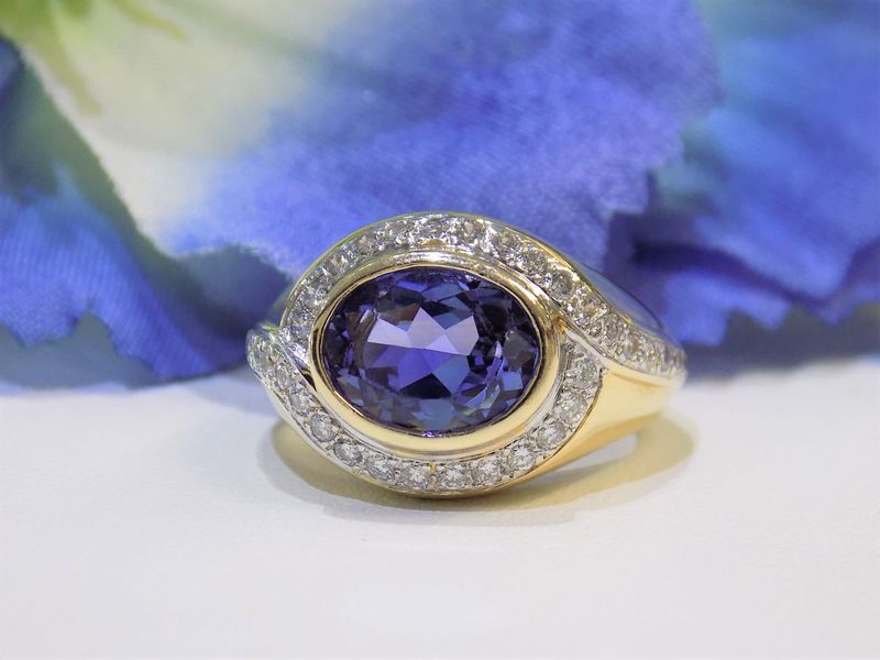Gold ring with a large, oval purple gemstone