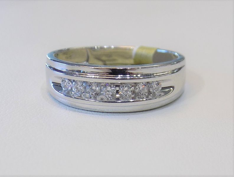 A white gold ring with seven small diamonds set across the band