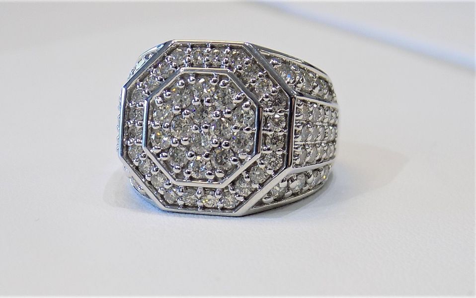 Diamond-studded ring on a white surface