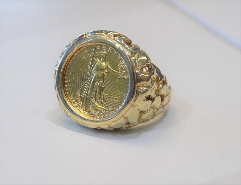 Gold ring with a gold coin set in the center