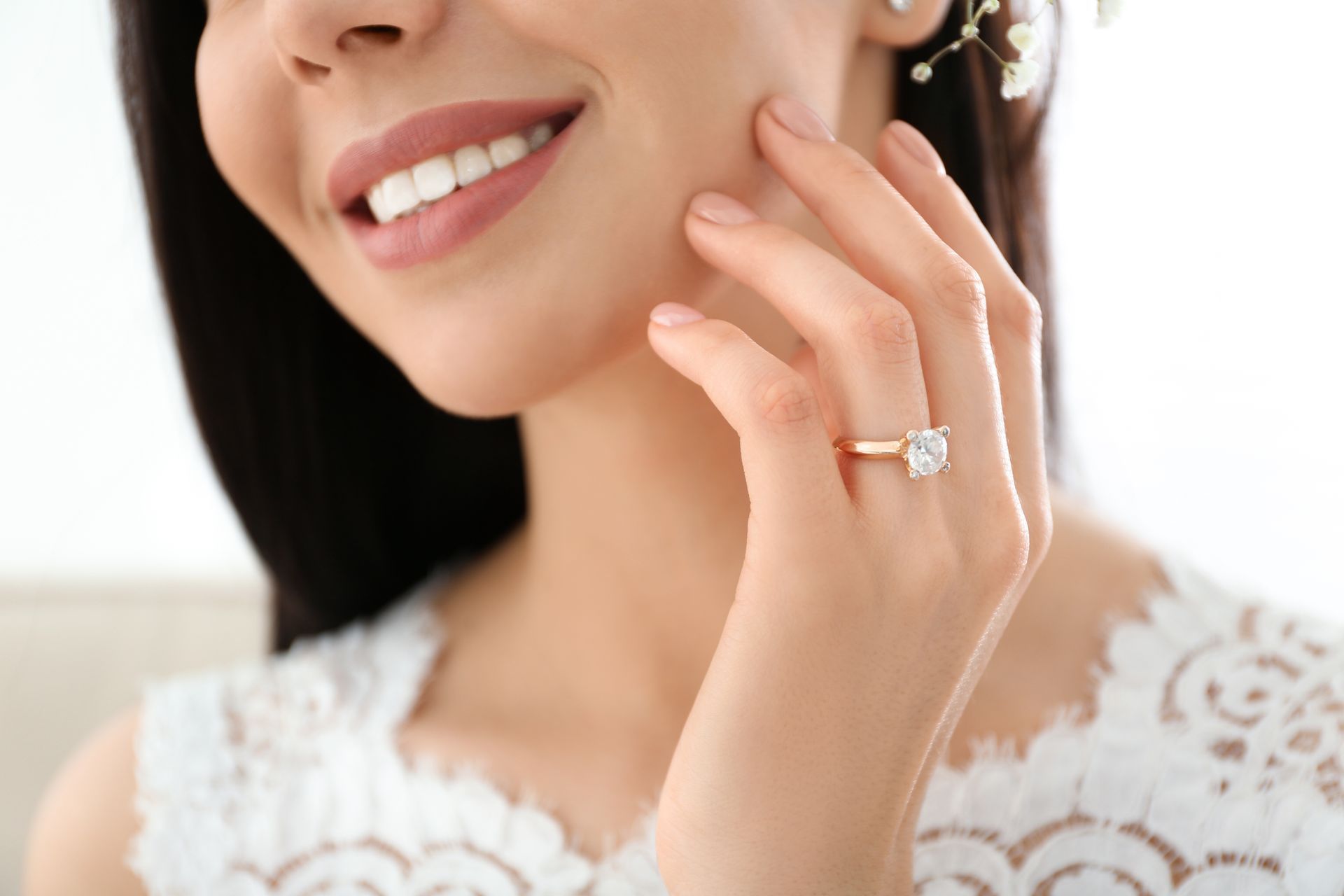 Woman with a square diamond engagement ring smiles