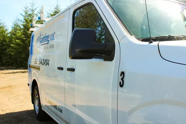 White cargo van parked outdoors with company logo and the number 3 on the side