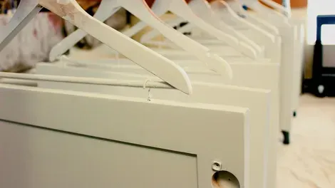 Row of white hanging file folders in a cabinet drawer, viewed from above.