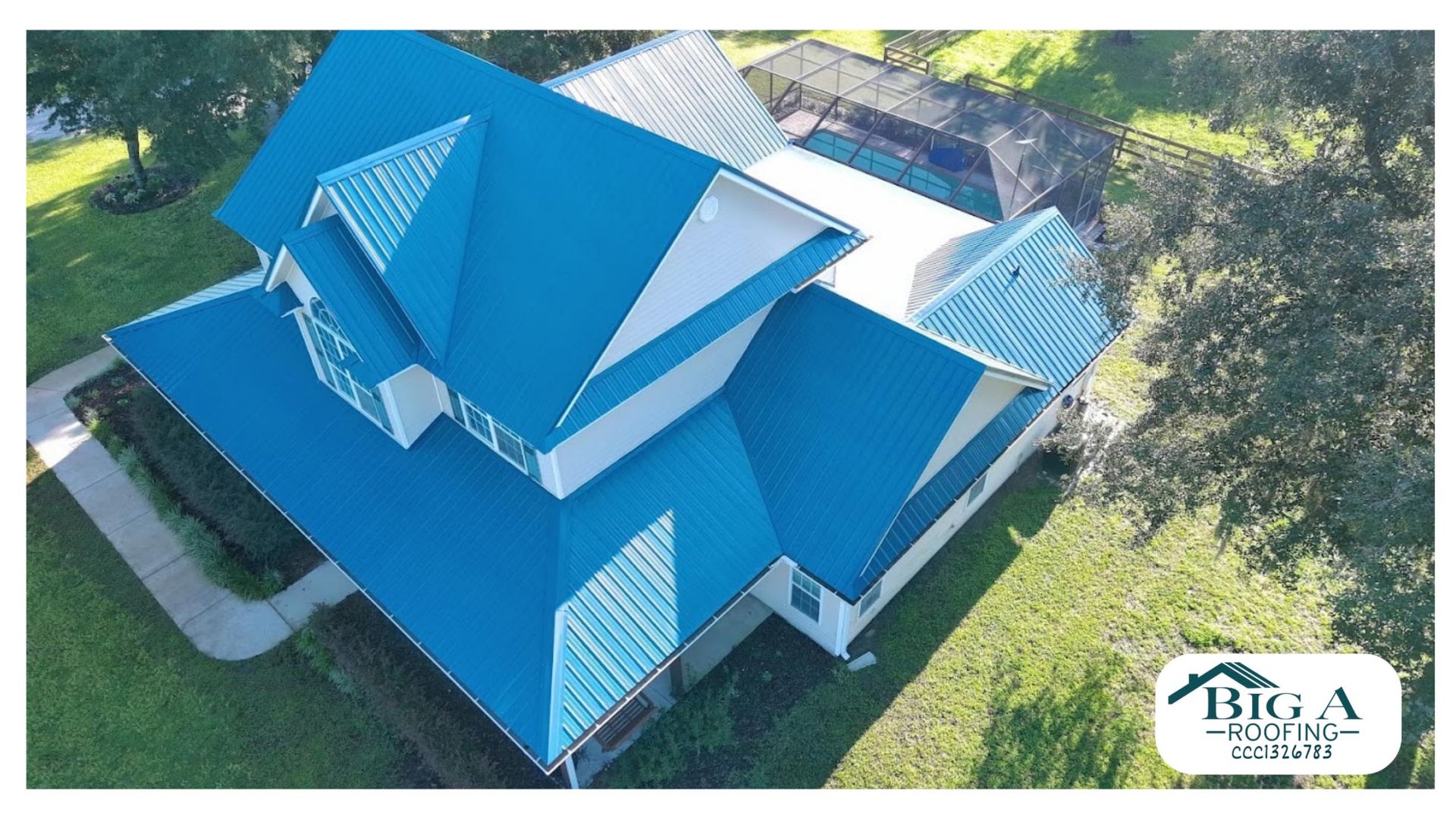 An aerial view of a suburban house featuring a vibrant blue metal roof, with a pool in the backyard and a company logo.