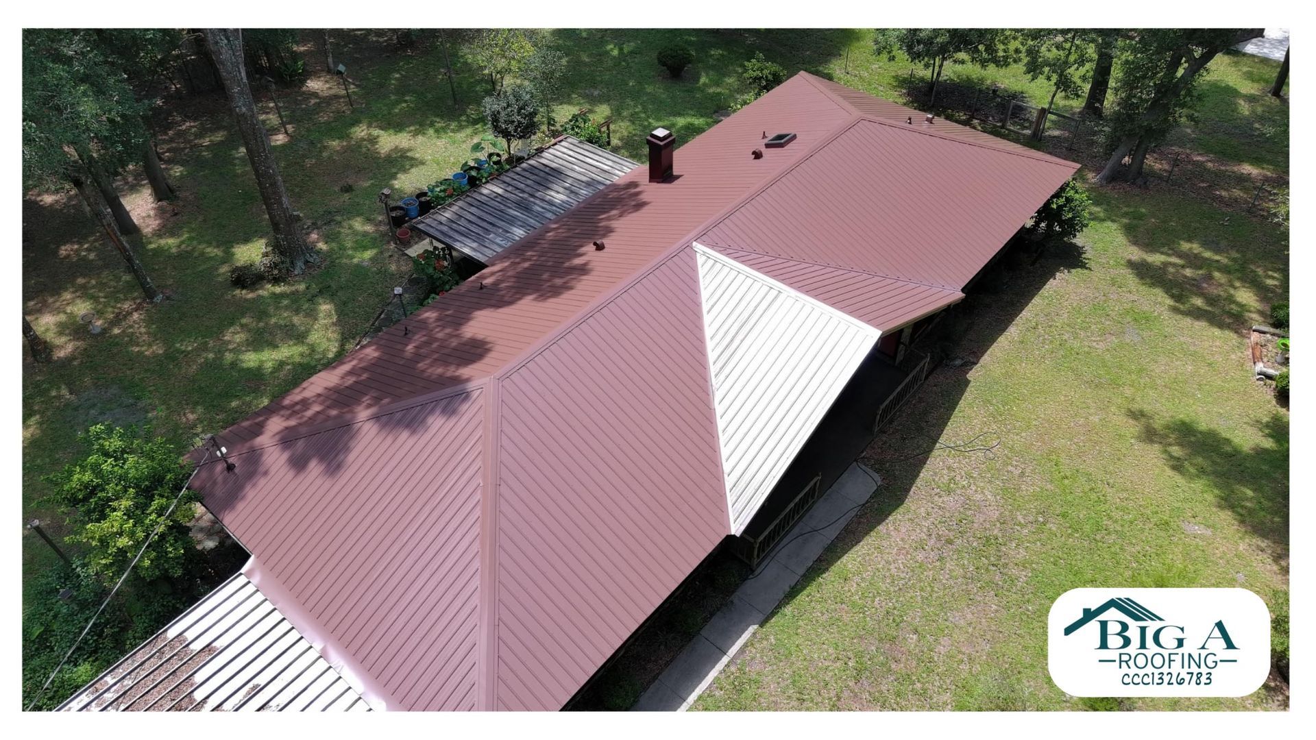 An aerial view of a house roof featuring mostly brown panels with a white triangular section, by Big A Roofing.