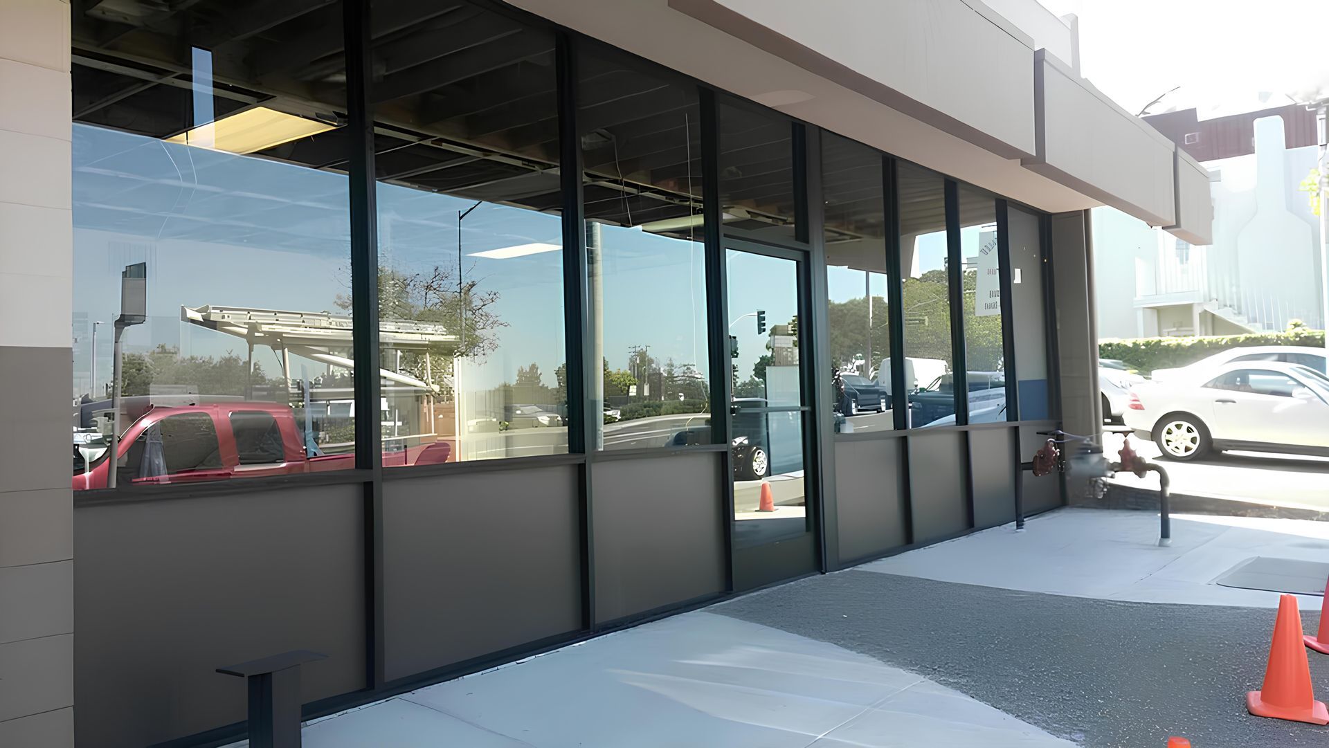 A building with a lot of windows and cars parked in front of it