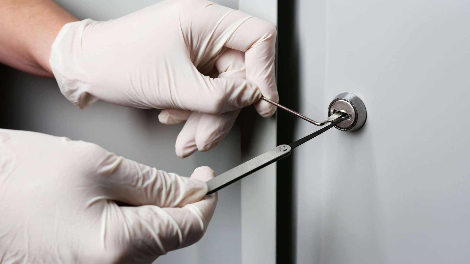A person is using a pen to open a door lock