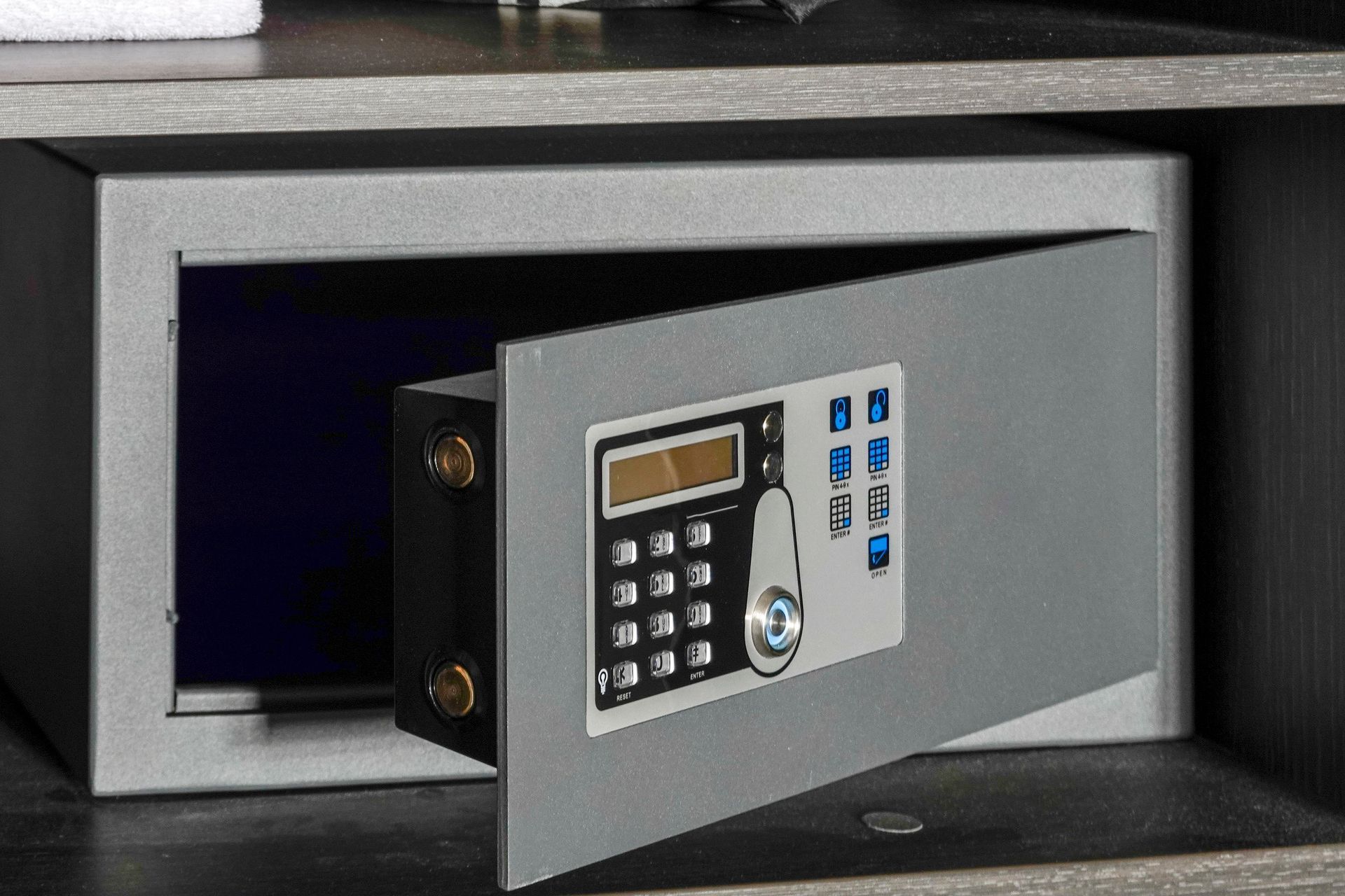 A digital safe with the door open is sitting on a shelf